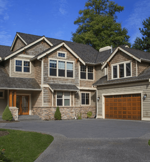 house with wood siding and big driveway